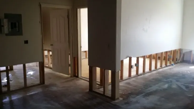 Basement rooms in Union, NJ with the drywall flood-cut to the studs for drying