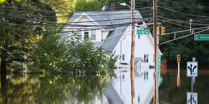 Storm floodwater covering a street and front yards in a New Jersey neighborhood near Union